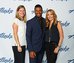 Kris Richey Curtis and Stacy Lill (wine sponsor with Delille) with Russell Wilson