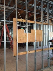 Backing installed for monitors and other hung furnishings.